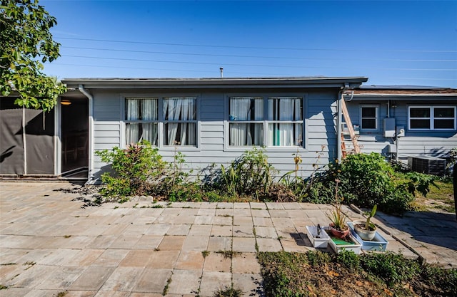 view of front of property featuring central AC and a patio