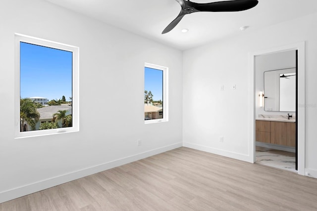 unfurnished bedroom featuring ceiling fan, connected bathroom, and light hardwood / wood-style floors