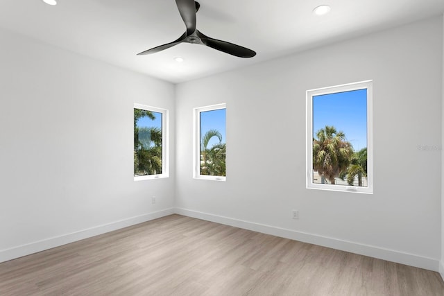 spare room featuring ceiling fan and light hardwood / wood-style flooring