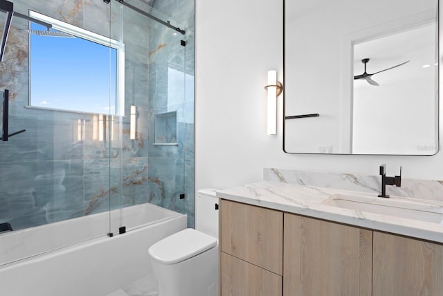 full bathroom with vanity, toilet, and combined bath / shower with glass door