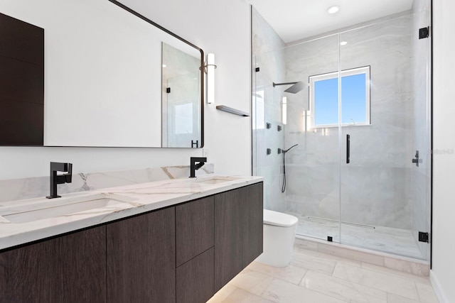 bathroom featuring vanity, toilet, and an enclosed shower