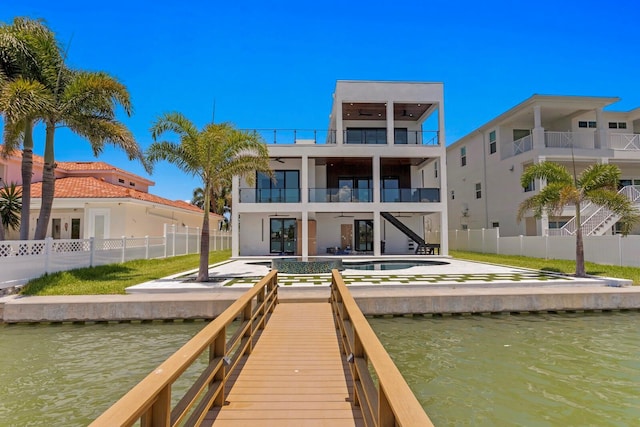 back of property featuring a balcony, a water view, and a patio area