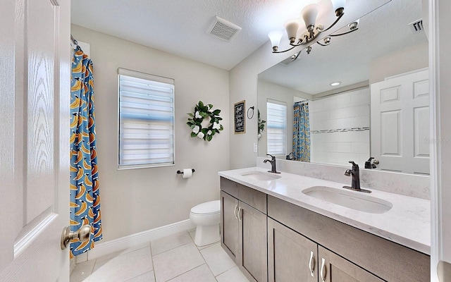 bathroom with vanity, a textured ceiling, tile patterned flooring, a chandelier, and toilet