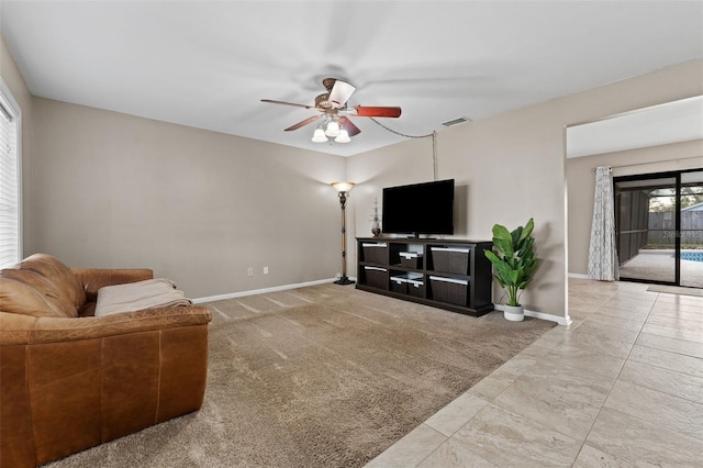 tiled living room with ceiling fan