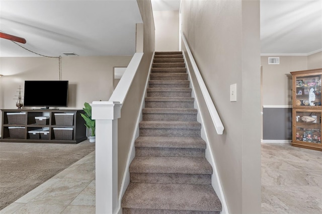 staircase featuring carpet and ornamental molding