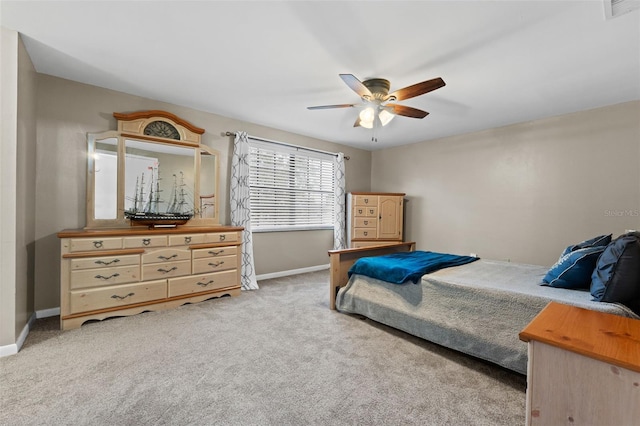 bedroom with ceiling fan and light carpet