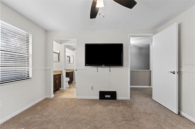 unfurnished living room featuring light colored carpet and ceiling fan