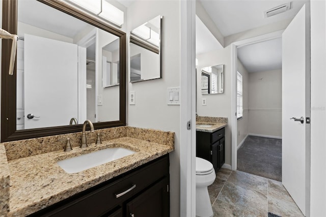 bathroom featuring vanity and toilet