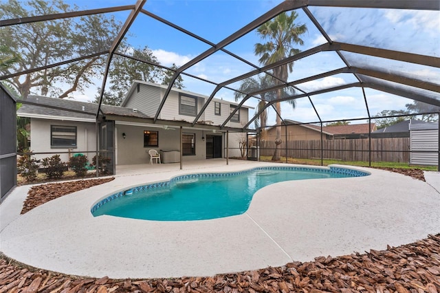 view of swimming pool with glass enclosure and a patio