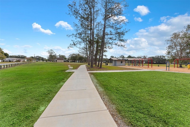 surrounding community featuring a yard and a playground