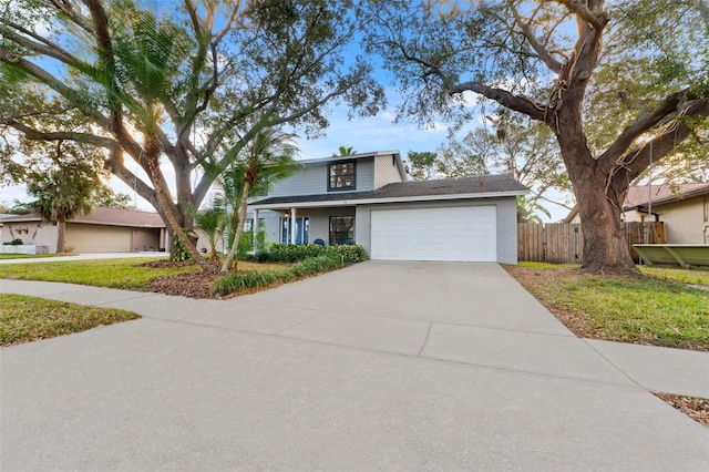 view of front of home with a front yard and a garage