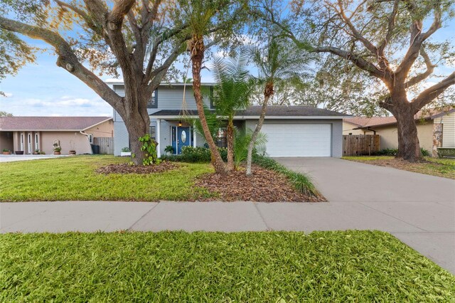 view of front facade with a garage and a front lawn