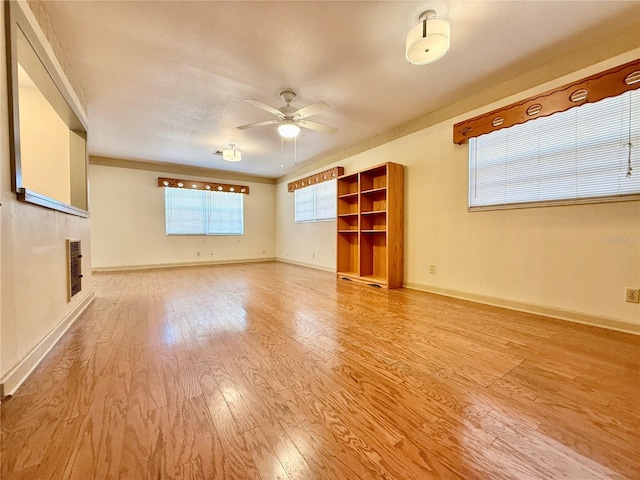 unfurnished living room featuring ceiling fan and light wood-type flooring