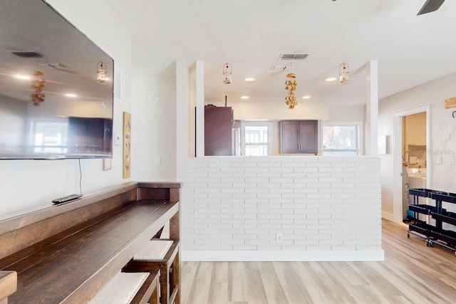 kitchen featuring hanging light fixtures and light wood-type flooring