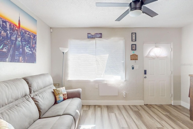 foyer with ceiling fan, light wood-type flooring, and a textured ceiling