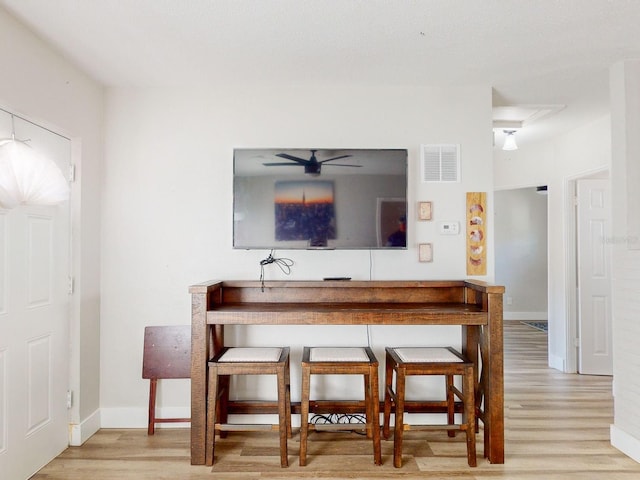 dining space featuring ceiling fan and light hardwood / wood-style flooring