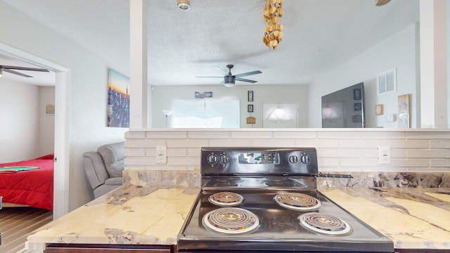 kitchen with a textured ceiling and electric range