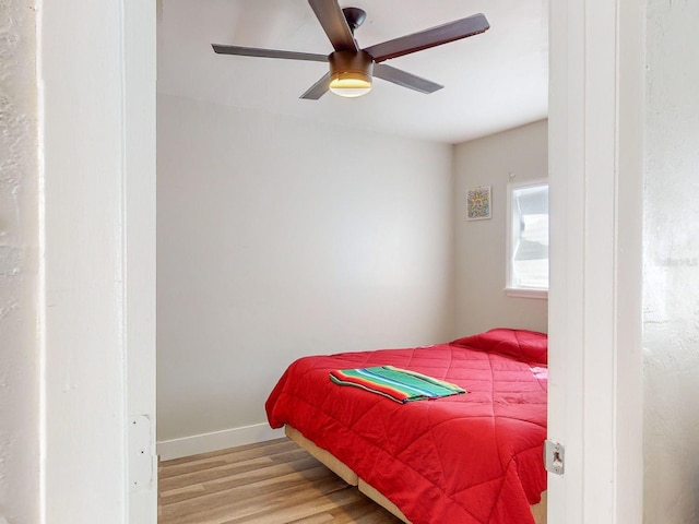 bedroom with ceiling fan and light wood-type flooring