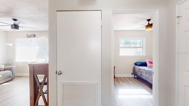 interior space featuring a textured ceiling and hardwood / wood-style flooring