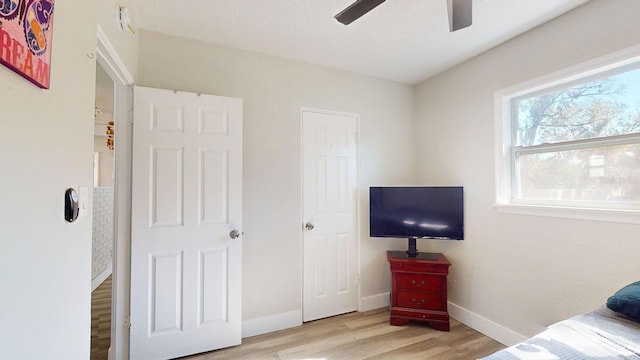 bedroom with ceiling fan and light hardwood / wood-style floors