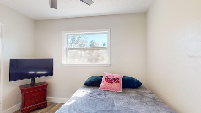 bedroom with ceiling fan and light wood-type flooring