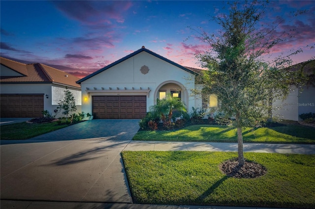 view of front of property featuring a lawn and a garage