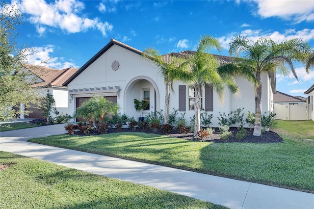 mediterranean / spanish-style home featuring a front yard