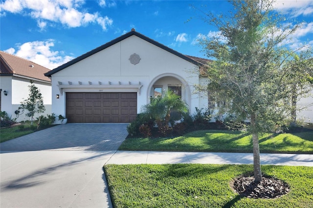 view of front of property with a garage and a front lawn