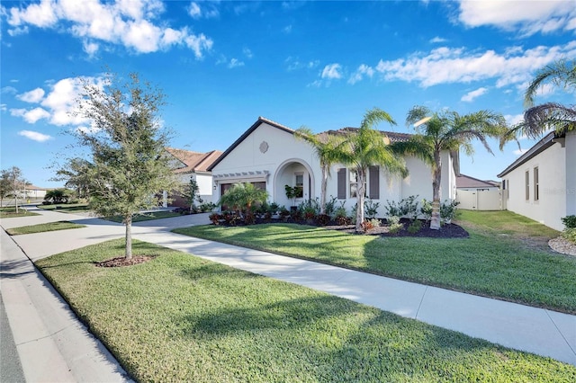 mediterranean / spanish home with a front yard