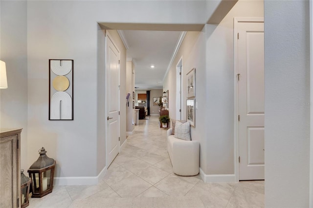 hallway featuring light tile patterned flooring and ornamental molding