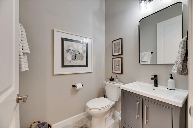 bathroom featuring tile patterned flooring, vanity, and toilet