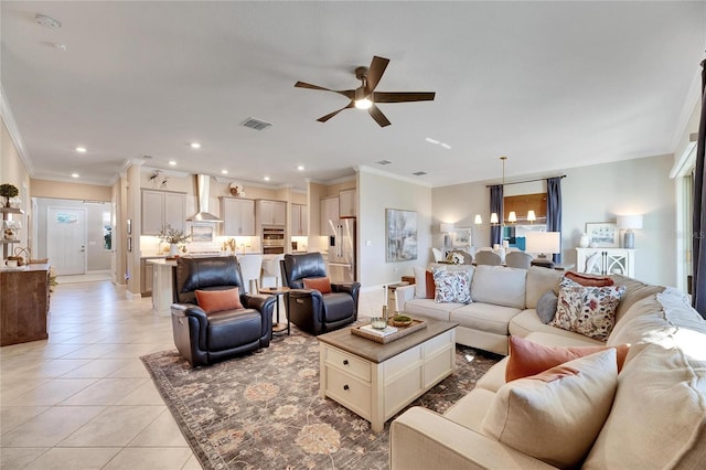 tiled living room with ceiling fan and crown molding