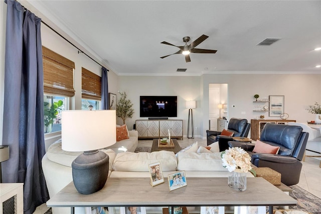 tiled living room featuring ceiling fan and crown molding