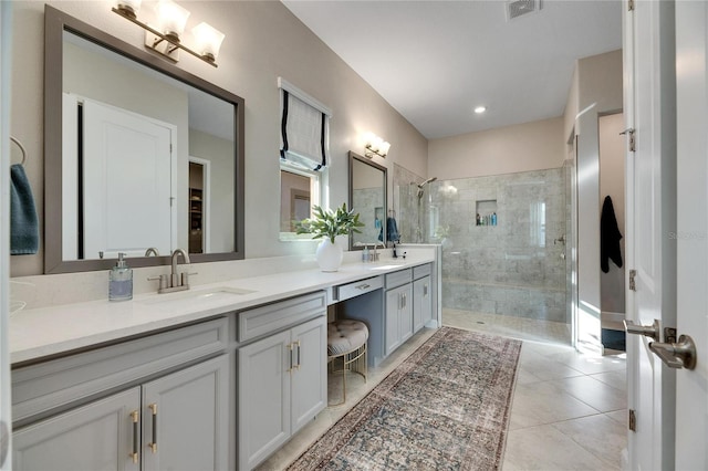 bathroom with tile patterned flooring, vanity, and an enclosed shower