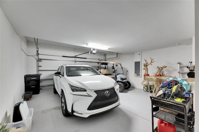 garage featuring electric panel and a garage door opener