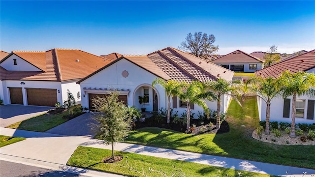 mediterranean / spanish-style home with a garage and a front yard