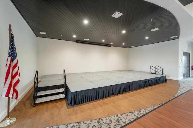 bedroom with light wood-type flooring and wood ceiling