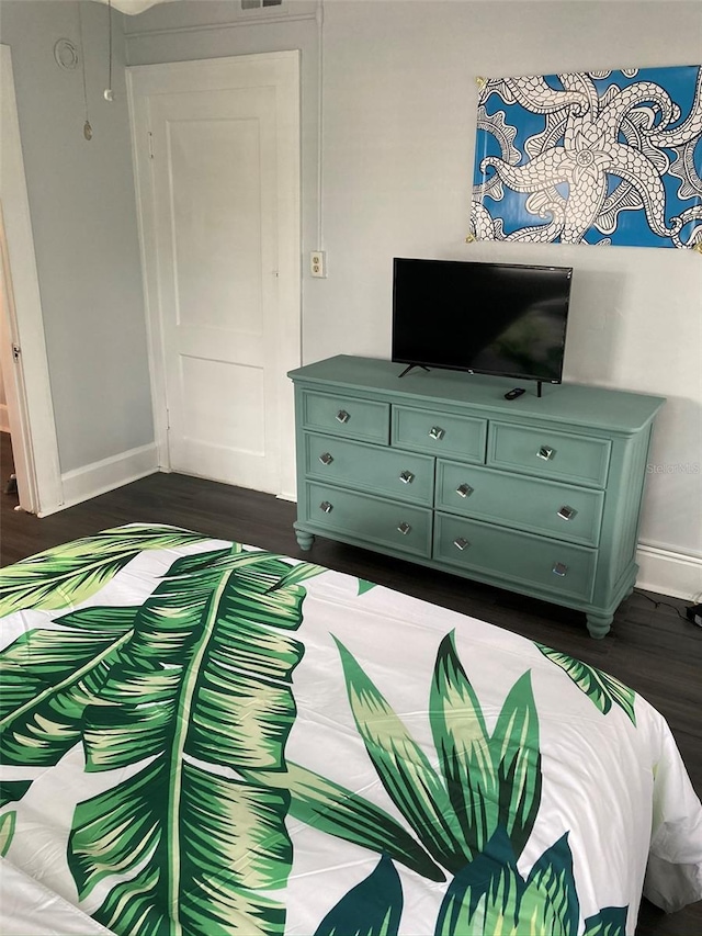 bedroom with dark wood-type flooring