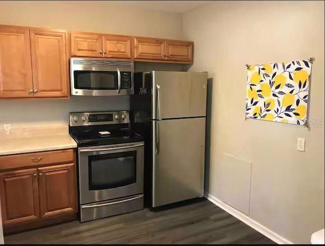 kitchen featuring dark hardwood / wood-style flooring and stainless steel appliances