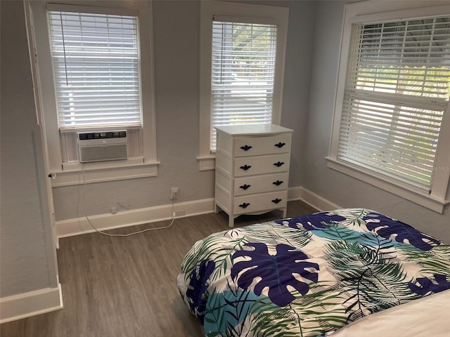 bedroom featuring dark hardwood / wood-style floors and cooling unit