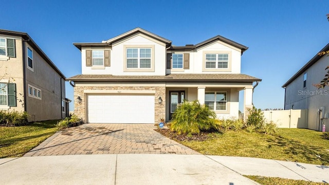 view of front of house with a front yard and a garage