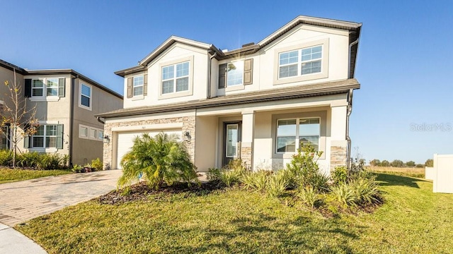 view of front of house with a front yard and a garage