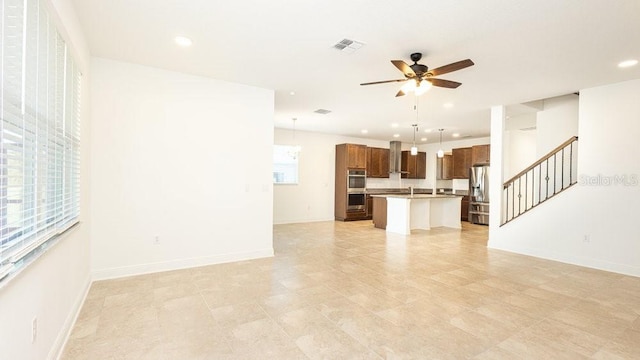 unfurnished living room featuring ceiling fan