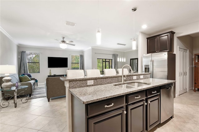 kitchen featuring sink, hanging light fixtures, ceiling fan, an island with sink, and stainless steel appliances