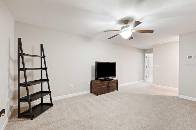 carpeted living room with ceiling fan and a textured ceiling