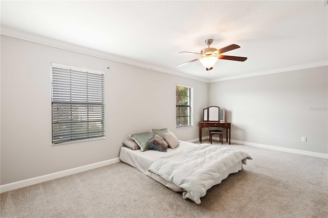 carpeted bedroom with ceiling fan and crown molding