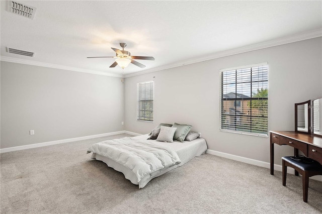 bedroom featuring carpet, ceiling fan, crown molding, and multiple windows