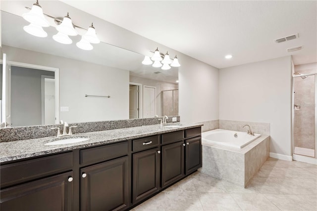 bathroom featuring tile patterned floors, vanity, and plus walk in shower