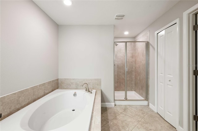 bathroom with tile patterned flooring and separate shower and tub