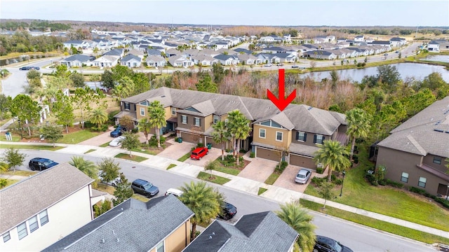 birds eye view of property with a water view